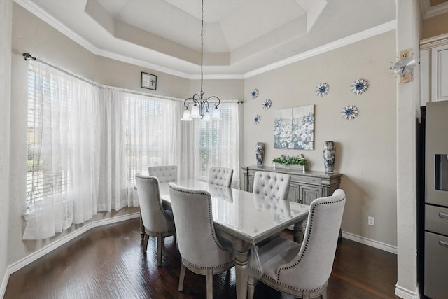 dining area featuring a notable chandelier, a raised ceiling, baseboards, and dark wood-style flooring