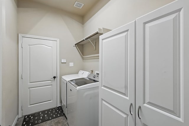 laundry room featuring tile patterned floors, visible vents, separate washer and dryer, and laundry area