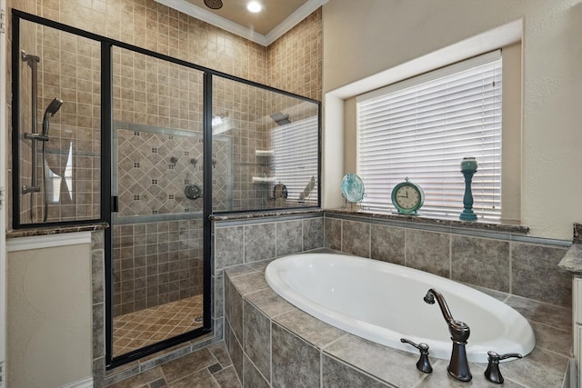 bathroom with a bath, a stall shower, and ornamental molding