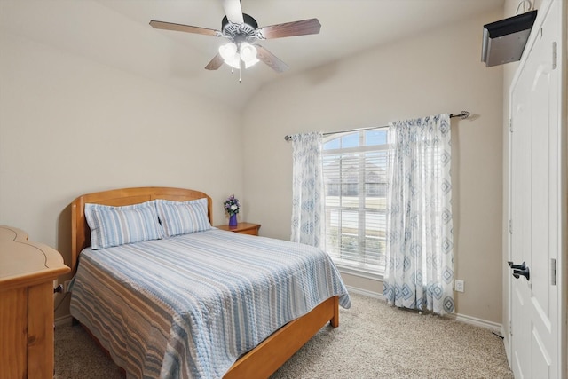 bedroom with vaulted ceiling, baseboards, carpet floors, and ceiling fan