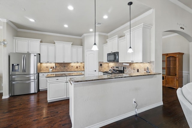 kitchen with stone counters, range, stainless steel fridge, and black microwave