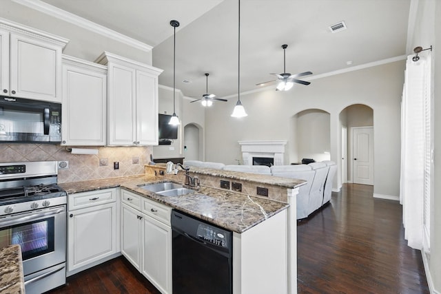 kitchen featuring visible vents, a peninsula, arched walkways, black appliances, and a sink