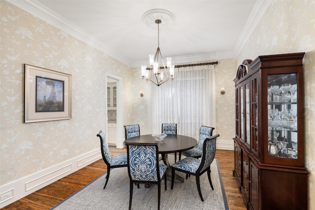 dining space with wallpapered walls, dark wood finished floors, baseboards, and a chandelier