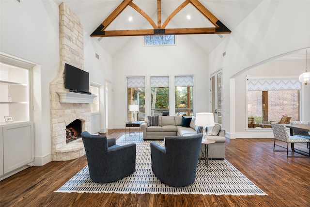 living area featuring high vaulted ceiling, wood finished floors, a fireplace, baseboards, and a chandelier