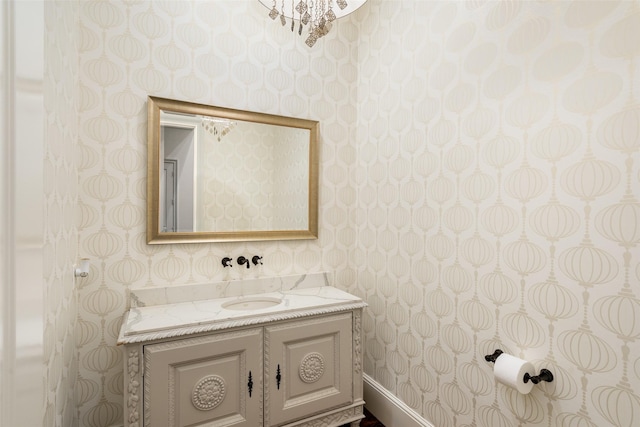 bathroom featuring wallpapered walls and vanity