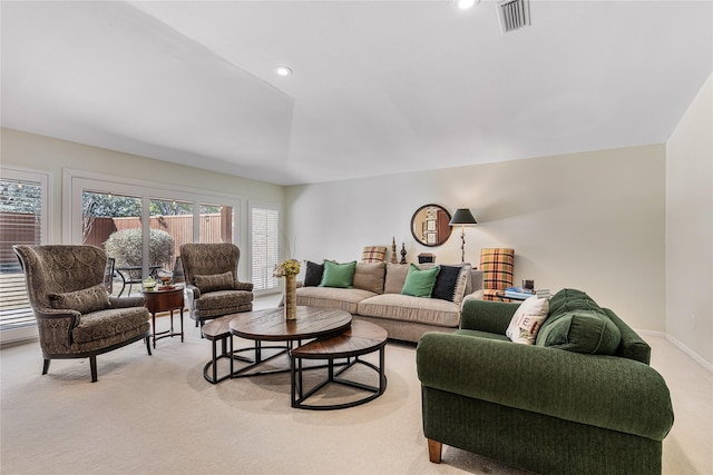 living room featuring recessed lighting, visible vents, baseboards, and light colored carpet