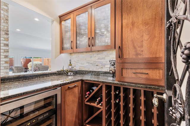 bar with a bar, recessed lighting, beverage cooler, and tasteful backsplash