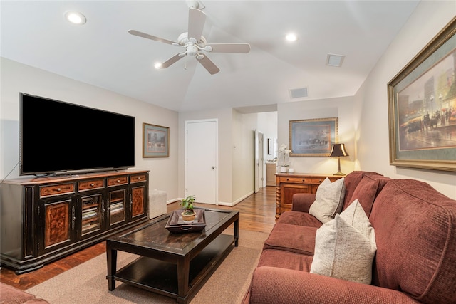 living room featuring vaulted ceiling, recessed lighting, wood finished floors, and visible vents