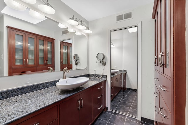 bathroom featuring tile patterned floors, visible vents, and vanity