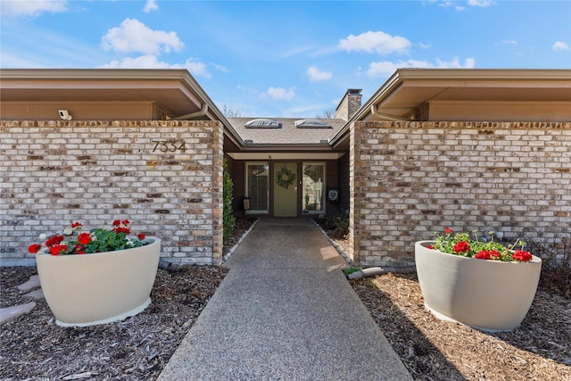 property entrance with brick siding