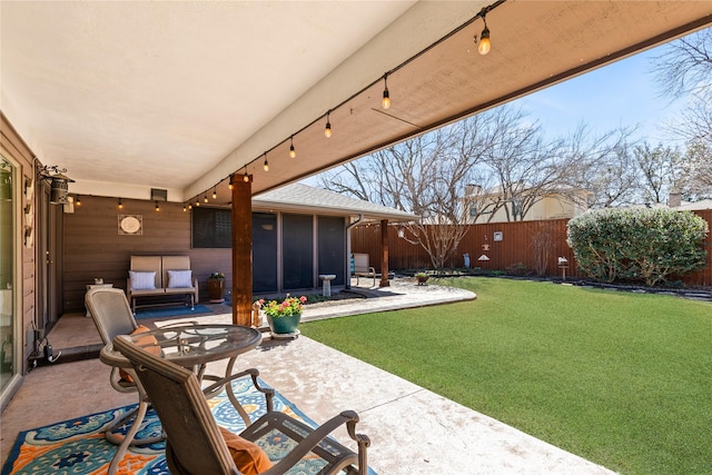 view of patio with a fenced backyard and a sunroom