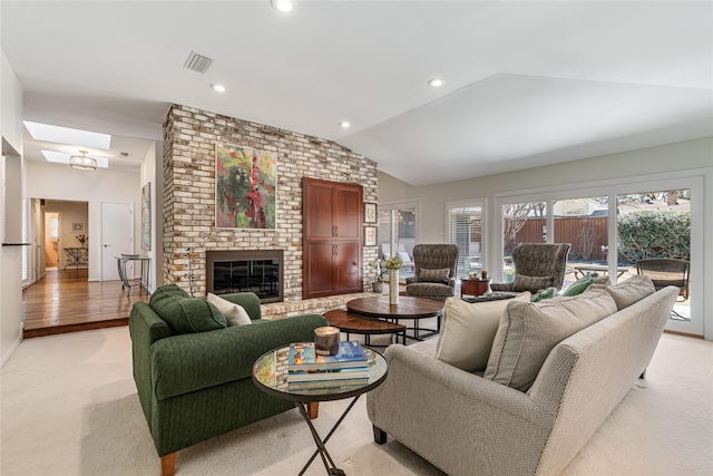 living room with visible vents, light carpet, recessed lighting, a fireplace, and vaulted ceiling