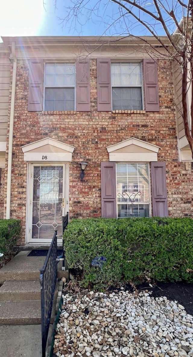 townhome / multi-family property featuring brick siding