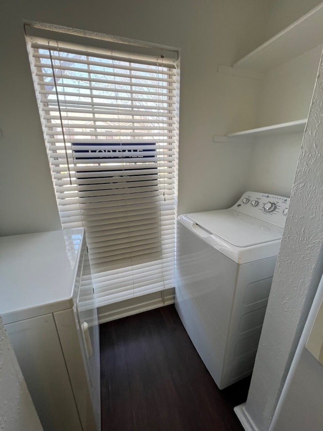 laundry area featuring dark wood finished floors, laundry area, and washer / clothes dryer