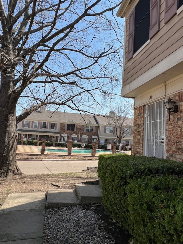 view of yard with a community pool and fence