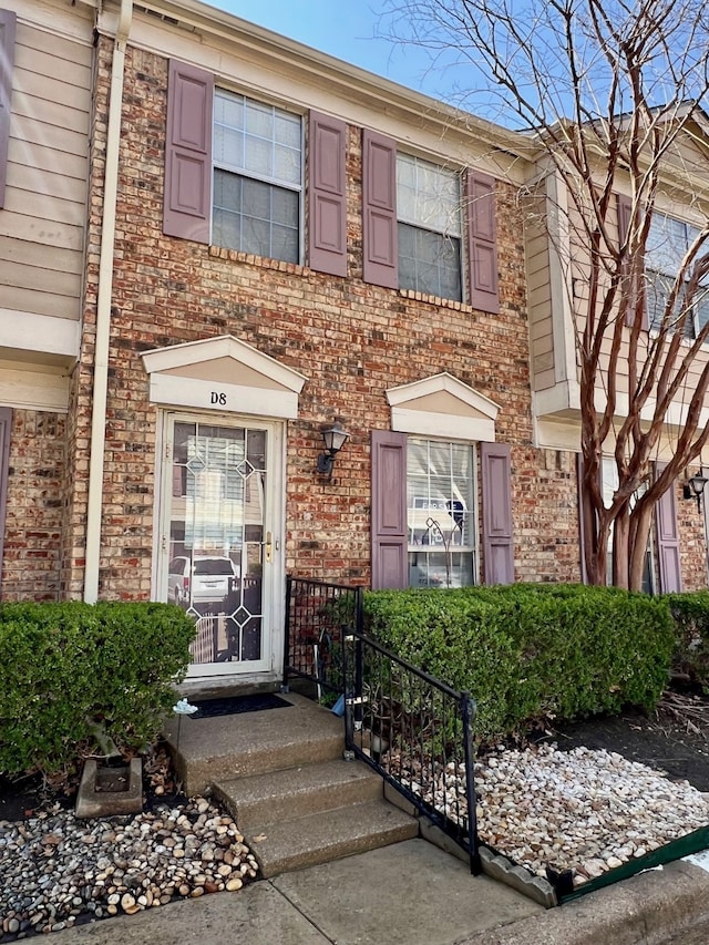 view of front of house with brick siding