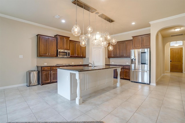 kitchen featuring decorative backsplash, appliances with stainless steel finishes, visible vents, and light tile patterned floors