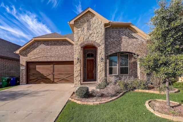 view of front of property with concrete driveway, brick siding, stone siding, and a garage