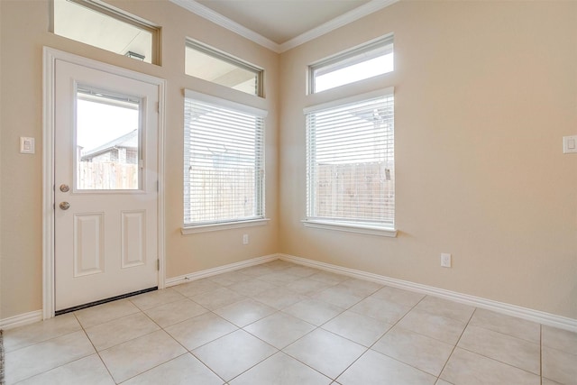 entryway with light tile patterned flooring, baseboards, and crown molding