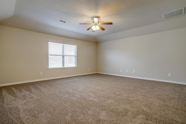 empty room with baseboards, a ceiling fan, visible vents, and carpet flooring