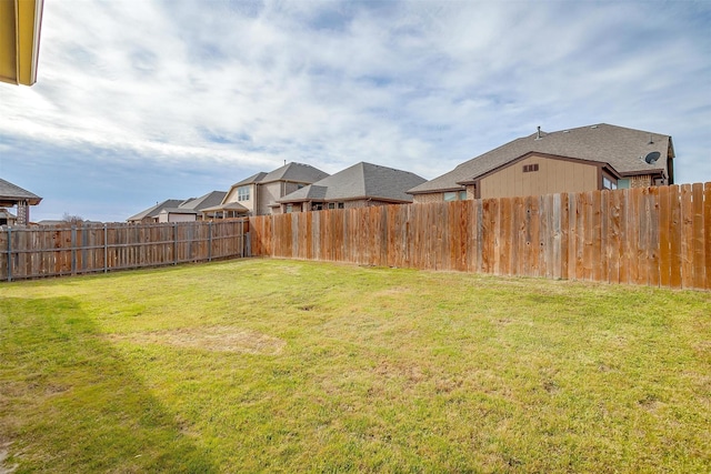 view of yard with a residential view and a fenced backyard