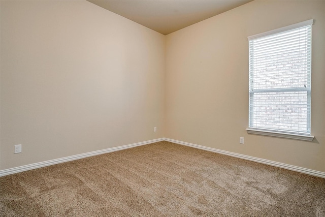 unfurnished room with carpet floors and baseboards