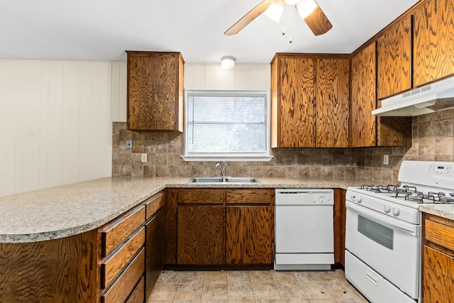 kitchen with under cabinet range hood, a ceiling fan, a sink, white appliances, and decorative backsplash