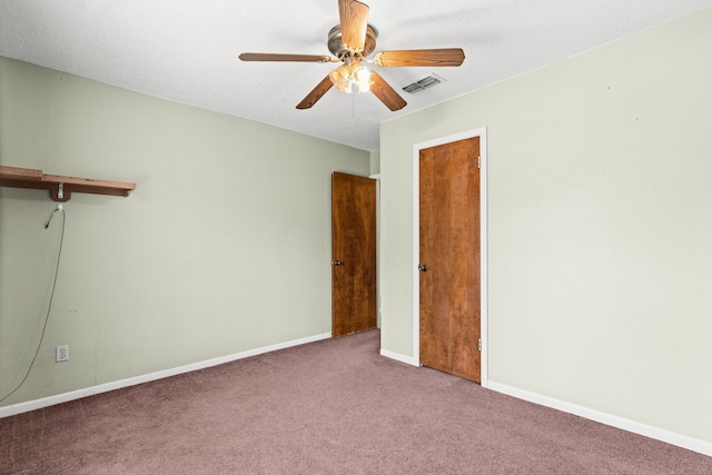 interior space featuring visible vents, baseboards, and ceiling fan