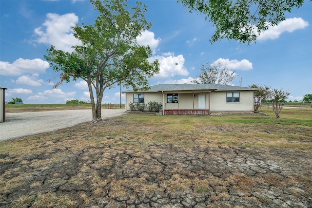 ranch-style house with a front yard and a porch