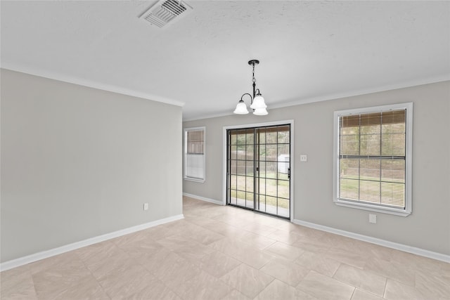 spare room with a chandelier, visible vents, crown molding, and baseboards