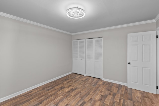 unfurnished bedroom featuring wood finished floors, baseboards, and ornamental molding