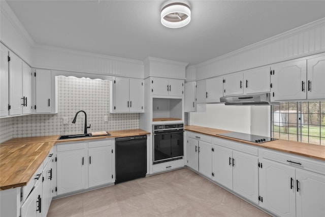 kitchen with black appliances, ornamental molding, under cabinet range hood, wood counters, and a sink