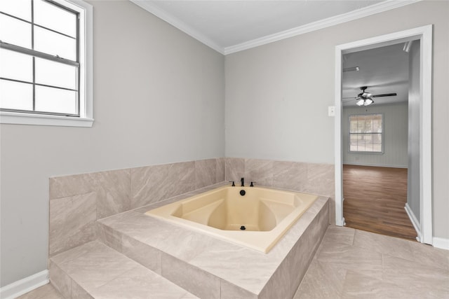 bathroom featuring tile patterned floors, baseboards, a garden tub, and crown molding