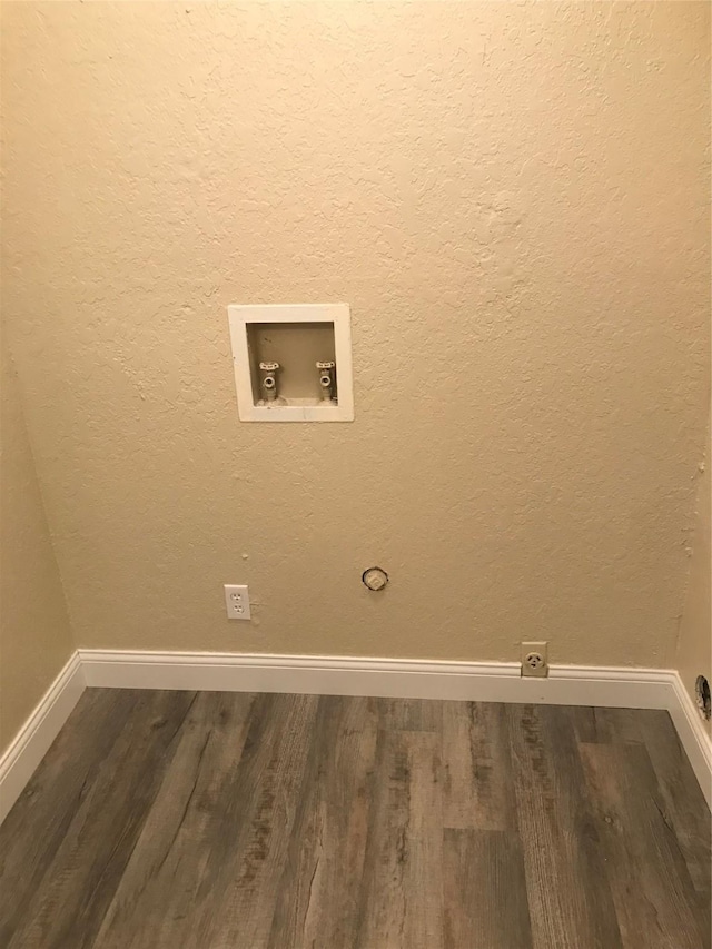 washroom with hookup for a washing machine, baseboards, dark wood-style flooring, and laundry area