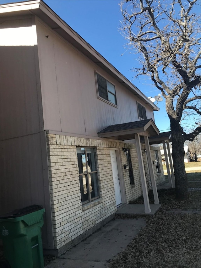 exterior space with brick siding