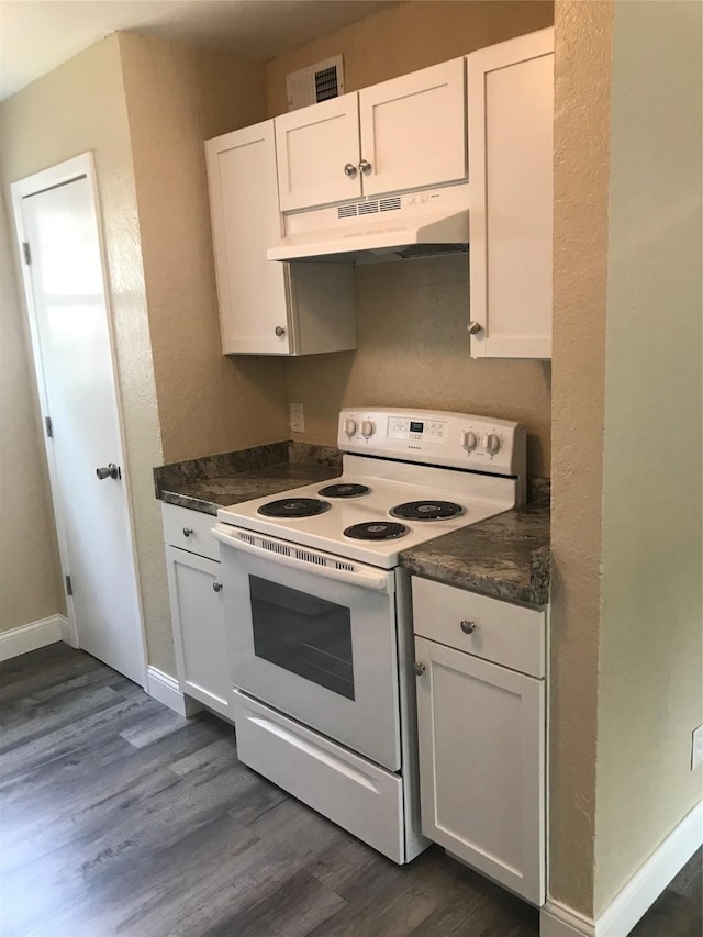 kitchen featuring white cabinetry, dark countertops, under cabinet range hood, and white range with electric stovetop