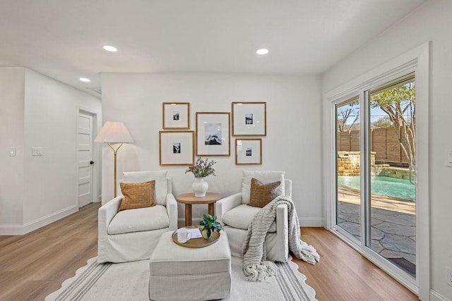 sitting room featuring recessed lighting, baseboards, and wood finished floors