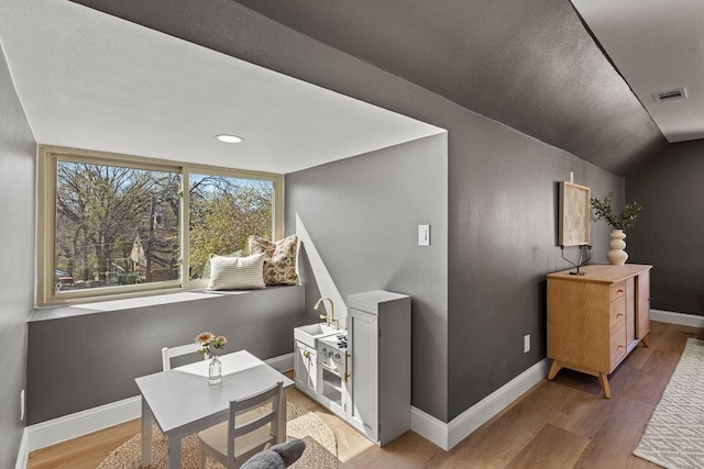 home office with visible vents, baseboards, and light wood-style floors