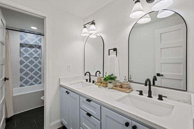 full bath featuring double vanity, shower / washtub combination, toilet, and a sink