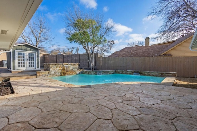 view of pool with a fenced in pool, french doors, a fenced backyard, and a patio