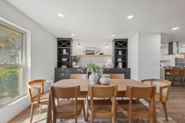 dining room with recessed lighting and light wood-type flooring