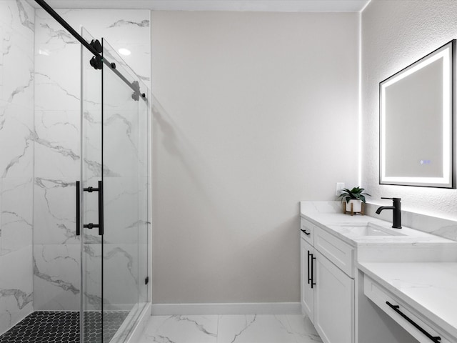 full bathroom with vanity, baseboards, marble finish floor, and a marble finish shower