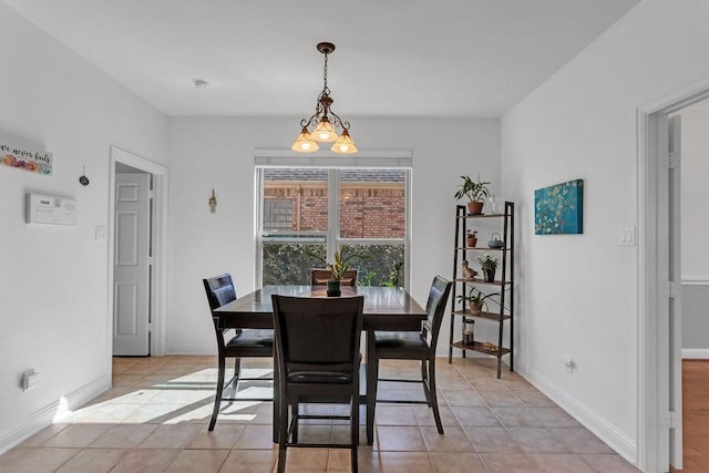 dining area with light tile patterned floors and baseboards