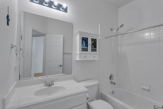 full bathroom with vanity, toilet, a textured wall, and shower / bathtub combination