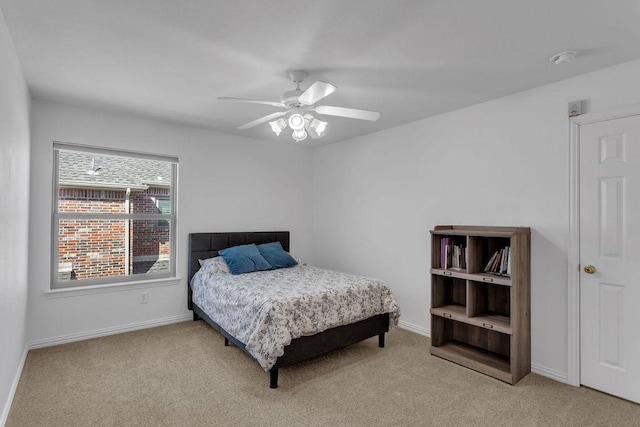 bedroom with baseboards, carpet floors, and a ceiling fan