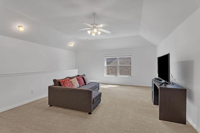 living room with baseboards, carpet, a ceiling fan, and vaulted ceiling