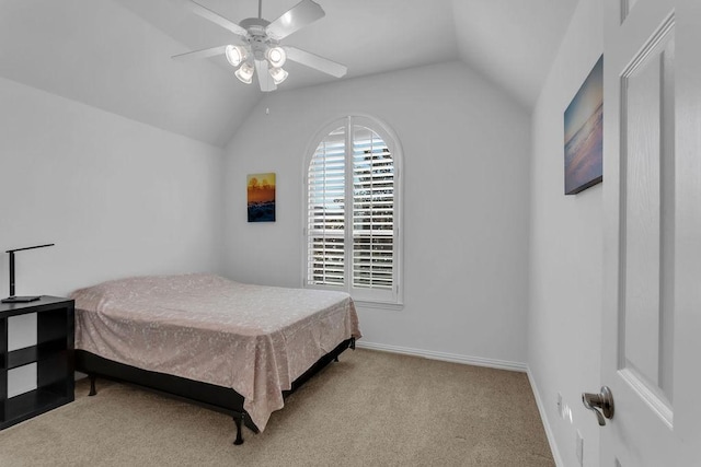 bedroom with carpet flooring, a ceiling fan, baseboards, and vaulted ceiling