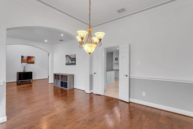 interior space with hardwood / wood-style floors, recessed lighting, baseboards, and ornamental molding