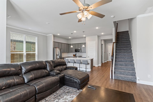 1504 Pleasant Knoll Trl, Aubrey, TX 76227 - living room featuring baseboards, stairway, ornamental molding, recessed lighting, and wood finished floors
