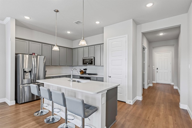 1504 Pleasant Knoll Trl, Aubrey, TX 76227 - kitchen with visible vents, gray cabinetry, a sink, tasteful backsplash, and stainless steel appliances